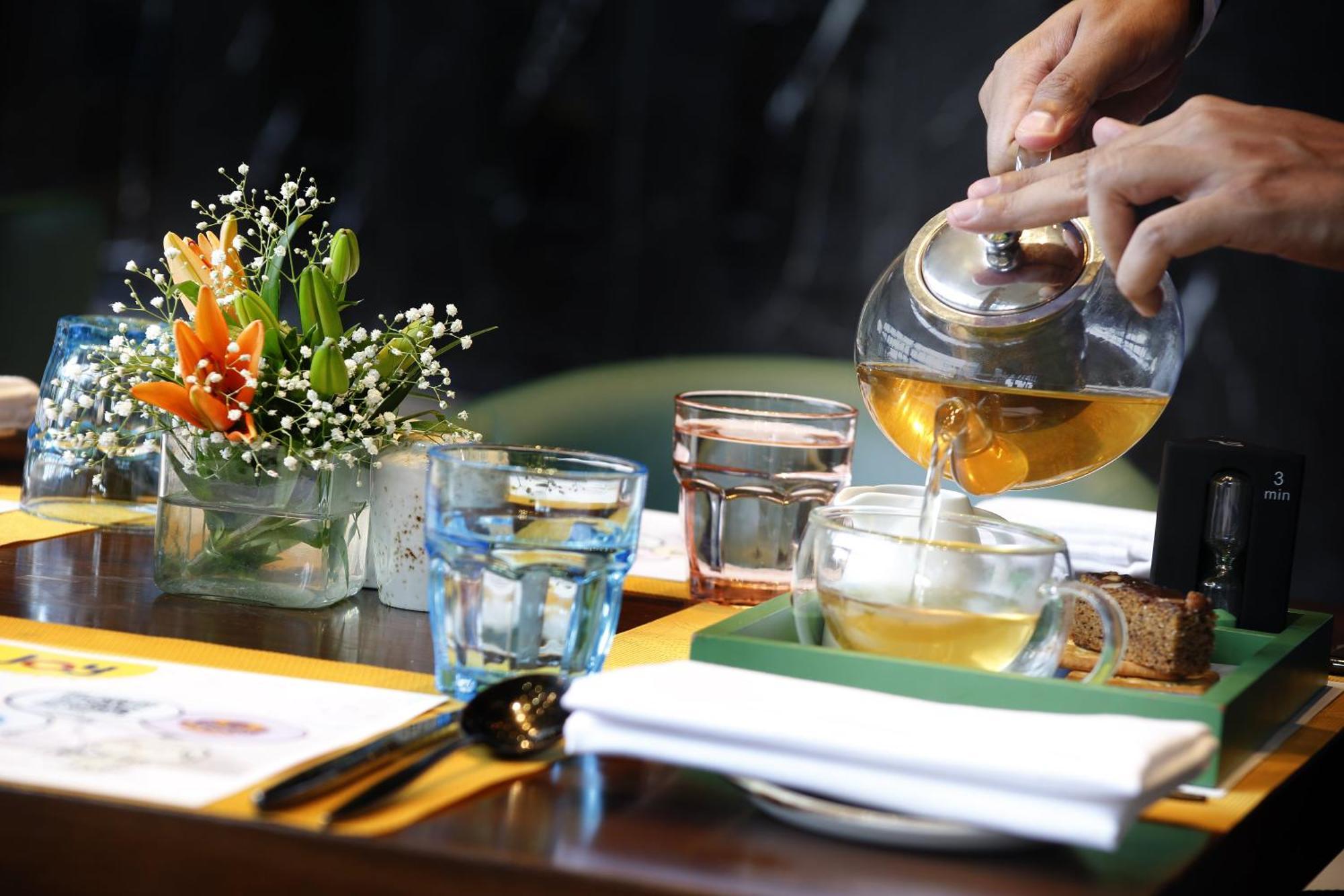 Novotel Kolkata Hotel And Residences Exterior foto A server pours tea at a restaurant